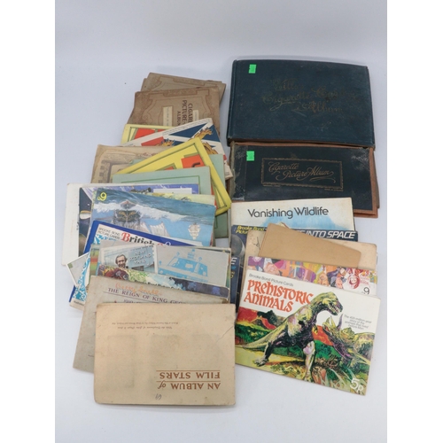 169 - Wills cigarette album to include various part sets, together with loose Brooke bond, and books some ... 