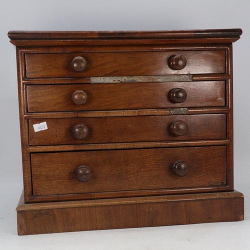 238 - An apprentice sized 4 drawer mahogany chest of drawers with inset leather? rexine top