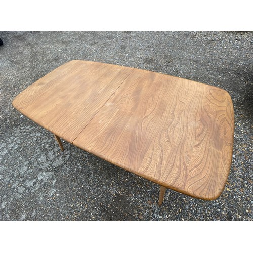 406 - Ercol extending dining table with fold out leaf stored under and fifth supporting leg together with ... 