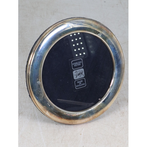 2 - A boxed circular silver photograph frame. Approx. 14cm dia'.