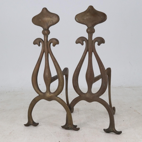 10 - A pair of brass Art Nouveau fire dogs measuring approx. 7