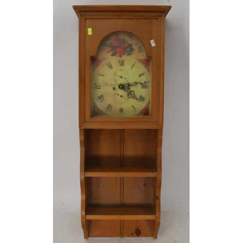 161 - A clock in pine wall unit. Measures approx. 32w x 14d x 84cmh