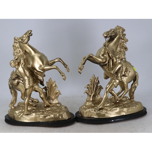 177 - Two metal horse statues sprayed gold, measuring approx. 16