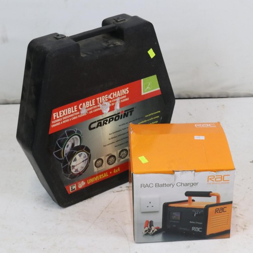 100 - A boxed RAC battery charger and a set of cased snow chains. Trade - spares or repairs