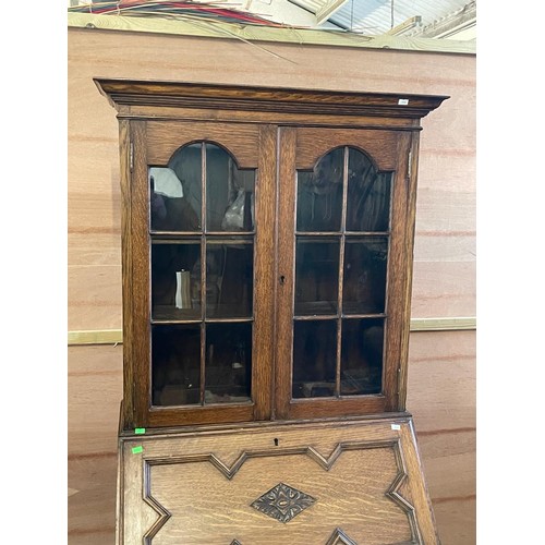 70 - An oak bureau with glazed bookcase above. It measures approx. 73w x 45d x 183cmh