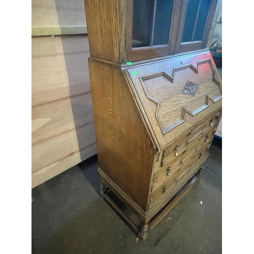 70 - An oak bureau with glazed bookcase above. It measures approx. 73w x 45d x 183cmh