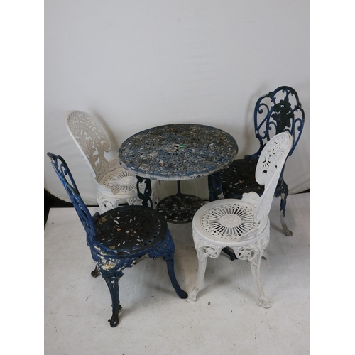 265 - A metal garden table with four chairs. The table measures approx. 85cm dia'.