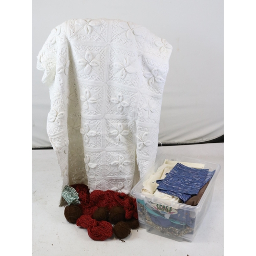 173A - A carton of scraps, wool, table-linen and large hand made bed spread.