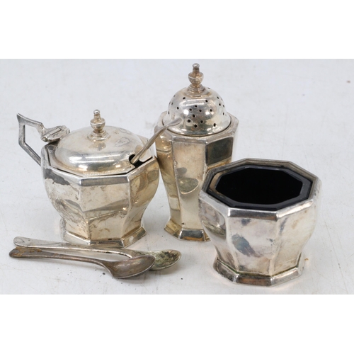 10 - A silver cruet set with blue glass liners (weight approx. 100g with liners removed)