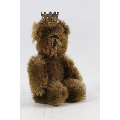 56 - Schuco miniature jointed teddy with metal crown (approx. 8cm tall)