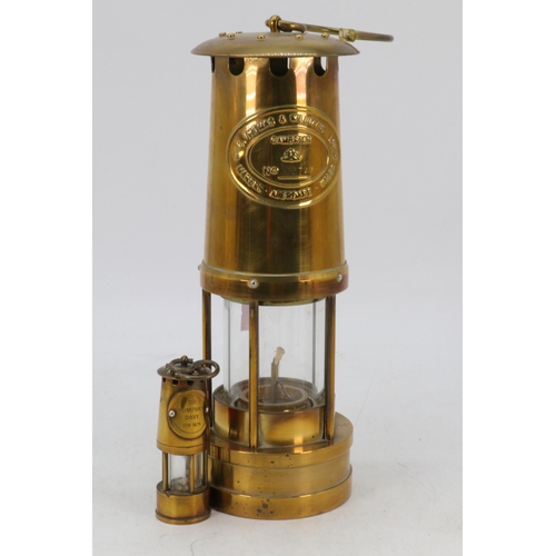 103 - Brass miners lamp together with another smaller similar.