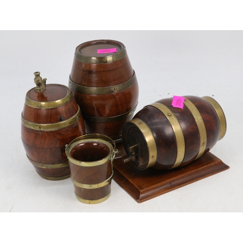 107 - Three wooden and brass bound small barrels together with a miniature wooden and brass bound bucket