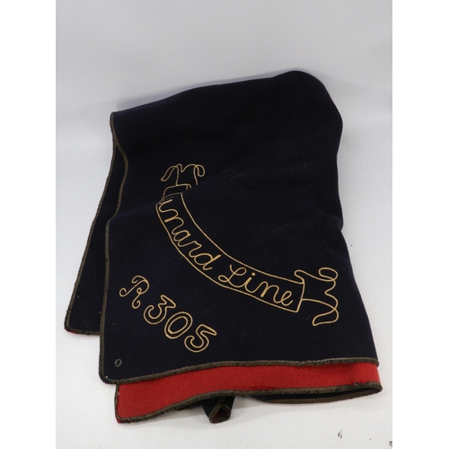 183 - Selection of memorabilia from QEII ship to include a blanket with stitching 