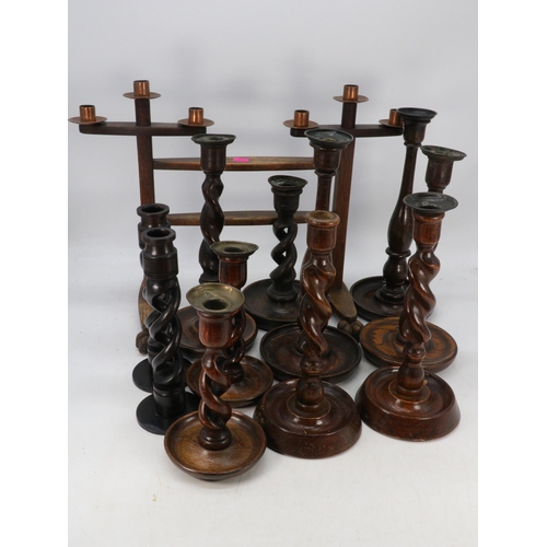 457 - Good selection of oak barley twist candlesticks together with an arts and crafts style candelabra