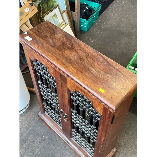 70 - A hardwood CD cabinet with oriental style grill to front. It measures approx. 63w x 20.5d x 88cmh