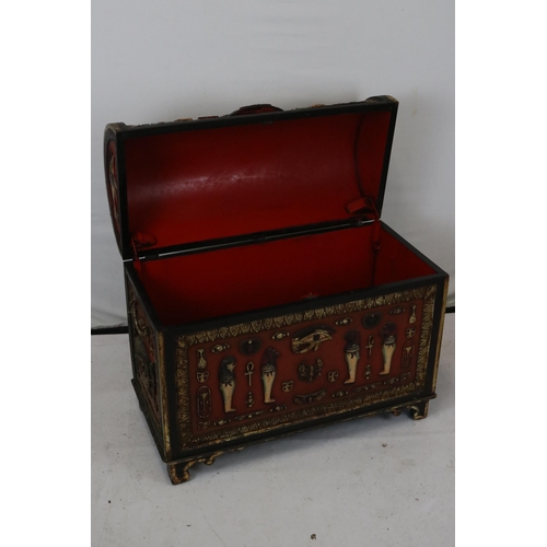 110 - A decorative storage casket with Egyptian motifs. It measures approx. 79w x 38d x 72cmh