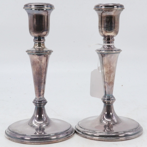 12 - A pair of silver hallmarked weighted candlesticks  (approx. weight 590g, approx. height 18cm).