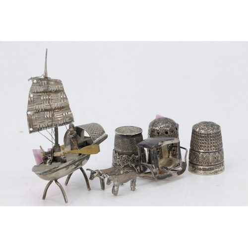 17 - A miniature silver junk ship together with a cart and horses, and three silver thimbles. (approx. we... 