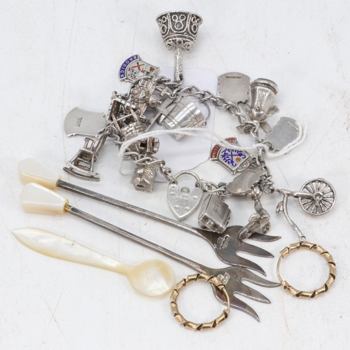 25 - Two silver forks, silver charm bracelet, mother of pearl spoon and a pair of 9ct gold earrings.