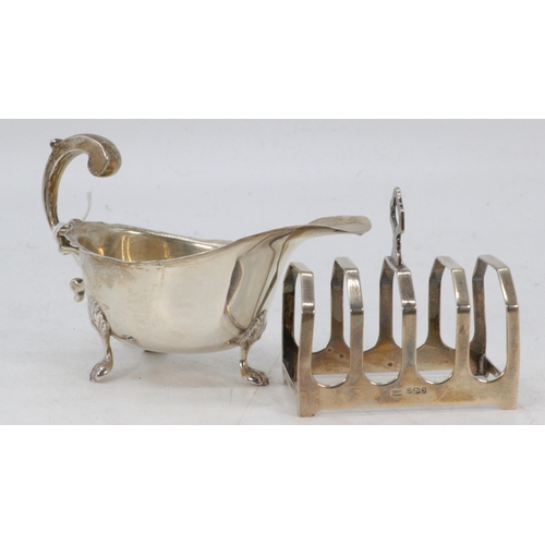 28 - A silver hallmarked sauce boat together with a silver toast rack. (total weight approx. 130g)