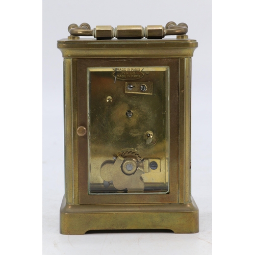 67 - A Castrell South Kensington brass cased carriage clock with visible escapement, appears over wound, ... 