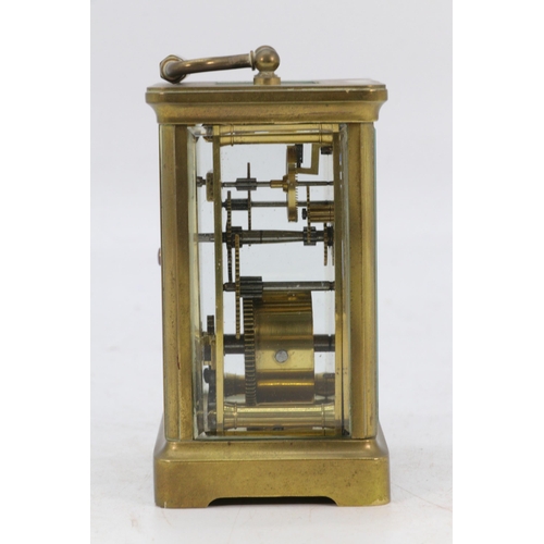 67 - A Castrell South Kensington brass cased carriage clock with visible escapement, appears over wound, ... 