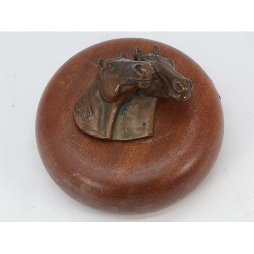 82 - Bronze? horseheads mounted to wooden plinth (diameter of plinth approx. 12cm)