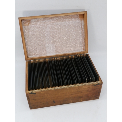 321 - A box containing glass negative slides