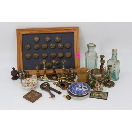 102 - A carton of assorted curios to include miniature brass candlesticks, royal artillery buttons, etc.