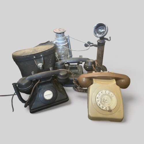 325 - A carton of vintage telephones together with a cased pair of Prinzlux 10x50 binoculars