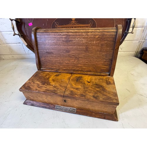 471 - An Oak tambour fronted pipe rack together with an Edwardian oval tray with brass handles