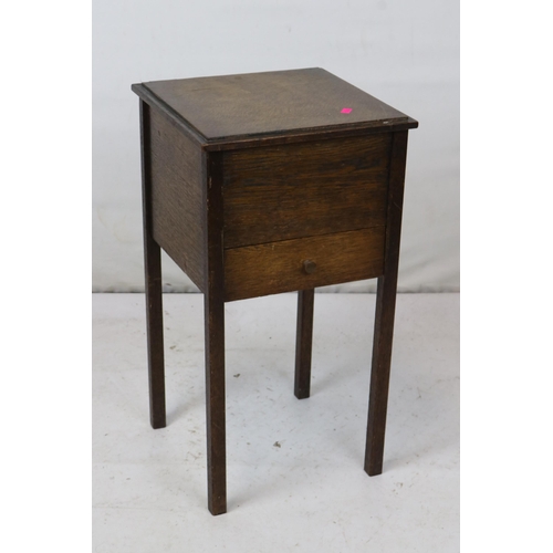 64 - An oak sewing box, corner chair, wooden carved tray, wicker basket and side table