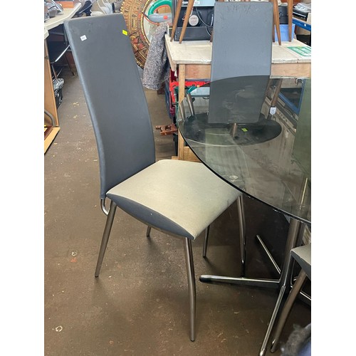 162 - Italian glass top dining table with four chairs (two shown) Measuring approx. 120cmw x 90cm together... 