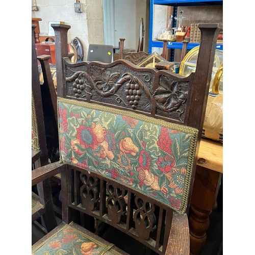 147 - Seven oak dining chairs with grape vine carved decoration to the back to include two carvers