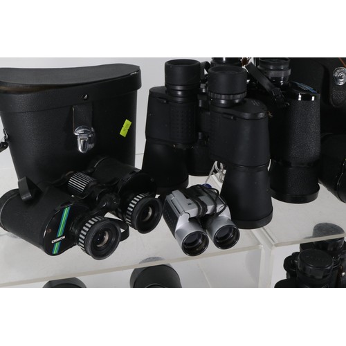 82 - Several pairs of assorted binoculars to include Bell & Howell, Pentax and Tasco etc