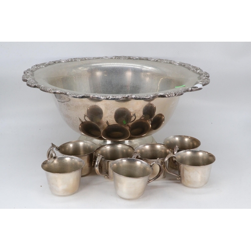 46 - Two large, silver-plated punch bowls, together with two ladles and an assortment of cups.