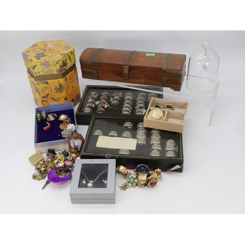 135 - A quantity of costume rings, silver backed mirror, earrings, tin of buttons and other costume jewell... 