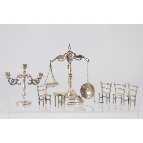 18 - Miniature Egyptian  silver candelabra, balance scales (slightly a/f) four chairs and a table (approx... 