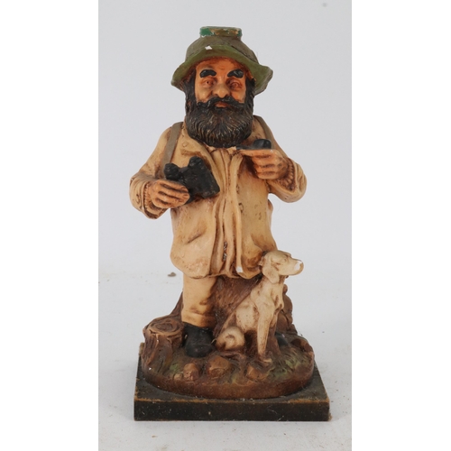 49 - A figurine of a rustic chap and dog.