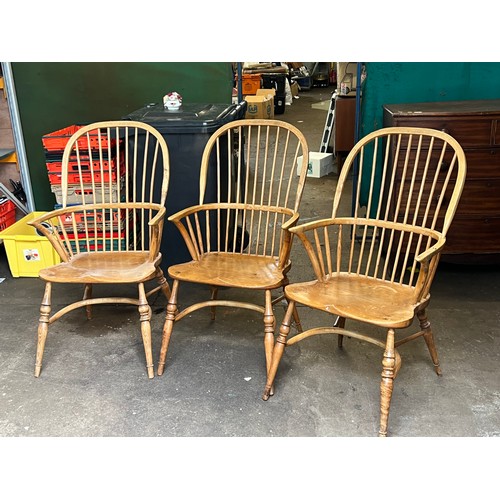 98 - Three farmhouse 
Windsor style elbow chairs. each approx 105cms tall overall