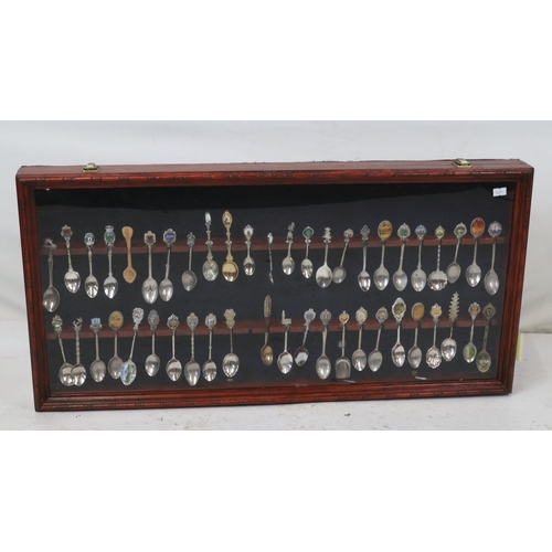 152 - Collection of assorted souvenir spoons in wall display case