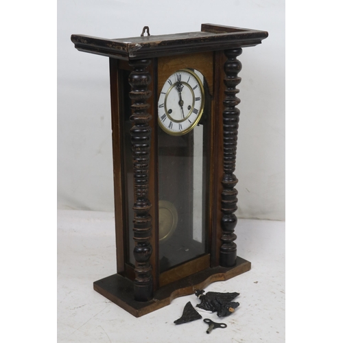 261 - A continental wall clock with pendulum and key. It measures approx. 39w x 19d x 58cmh. It comes with... 