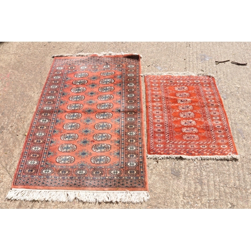 278 - Two oriental rugs with a red ground. The larger is approx. 150 x 94cm and the smaller 88 x 66cm.