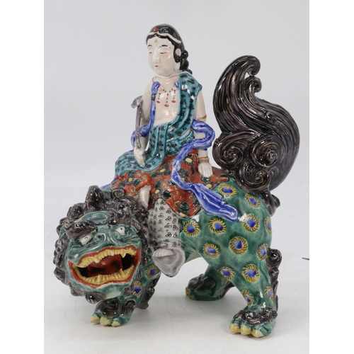 63 - Oriental figure riding a mystical Qillin, (approx. 23cm tall) with original bill of sale