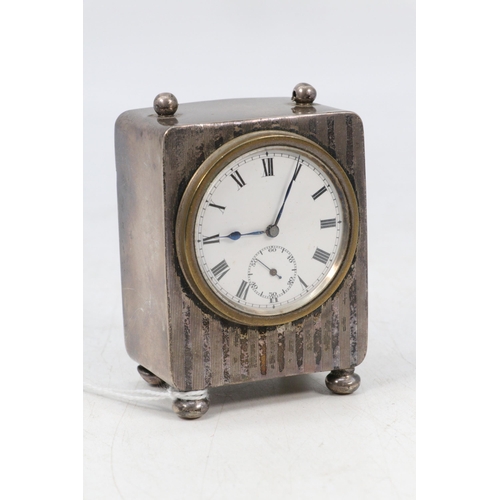 27 - Silver cased miniature mantle clock missing top handle bar