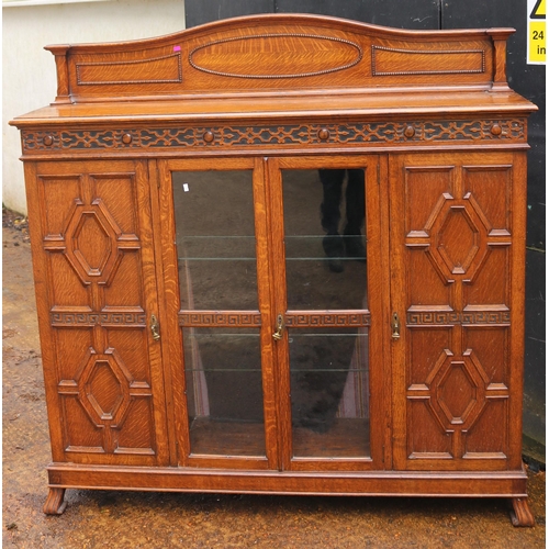 56 - Oak narrow cabinet with central display behind two glazed doors and two end cupboards with raised ba... 