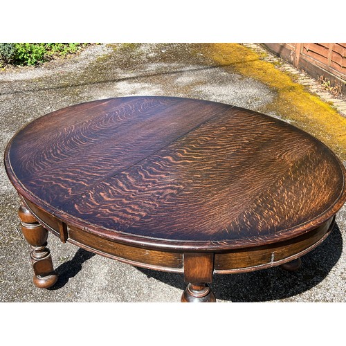 131 - Oak oval extending dining table with winder and two extra leaves measures approx. without leaves 150... 