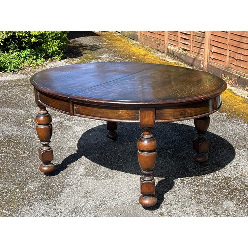 131 - Oak oval extending dining table with winder and two extra leaves measures approx. without leaves 150... 