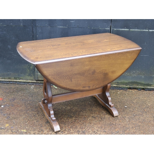 135 - Dark wood Ercol style drop leaf table measures approx. 59cm x 117cm unextended (extended 127cm)