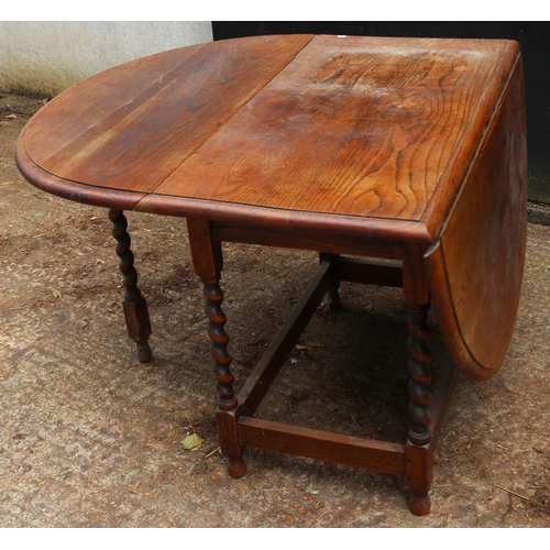 136 - Oak gate leg table with barley twist legs measures approx. 53cm x 102 unextended (extended 152cm)